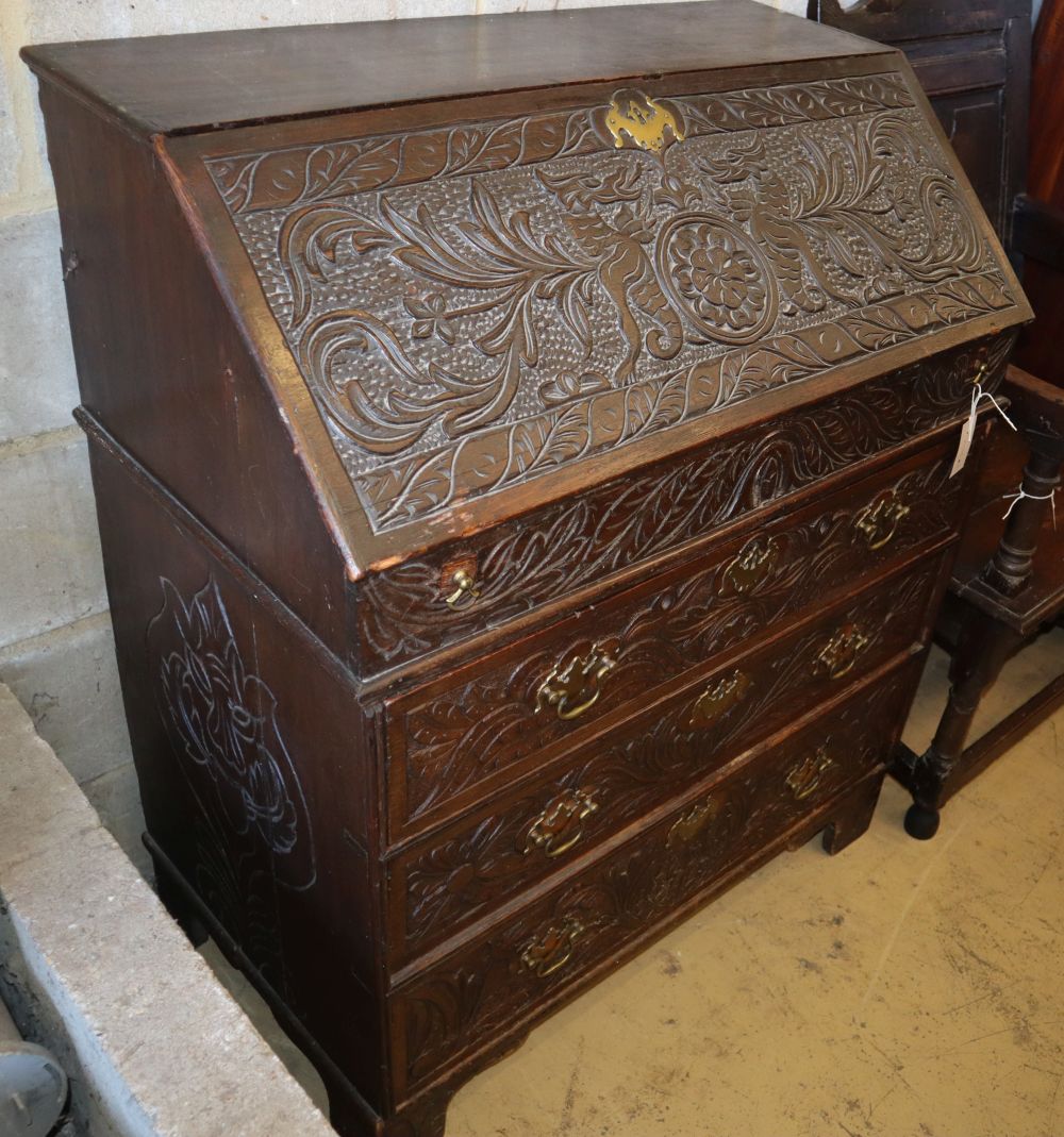 An 18th century oak bureau, later carved, W.86cm, D.50cm, H.105cm